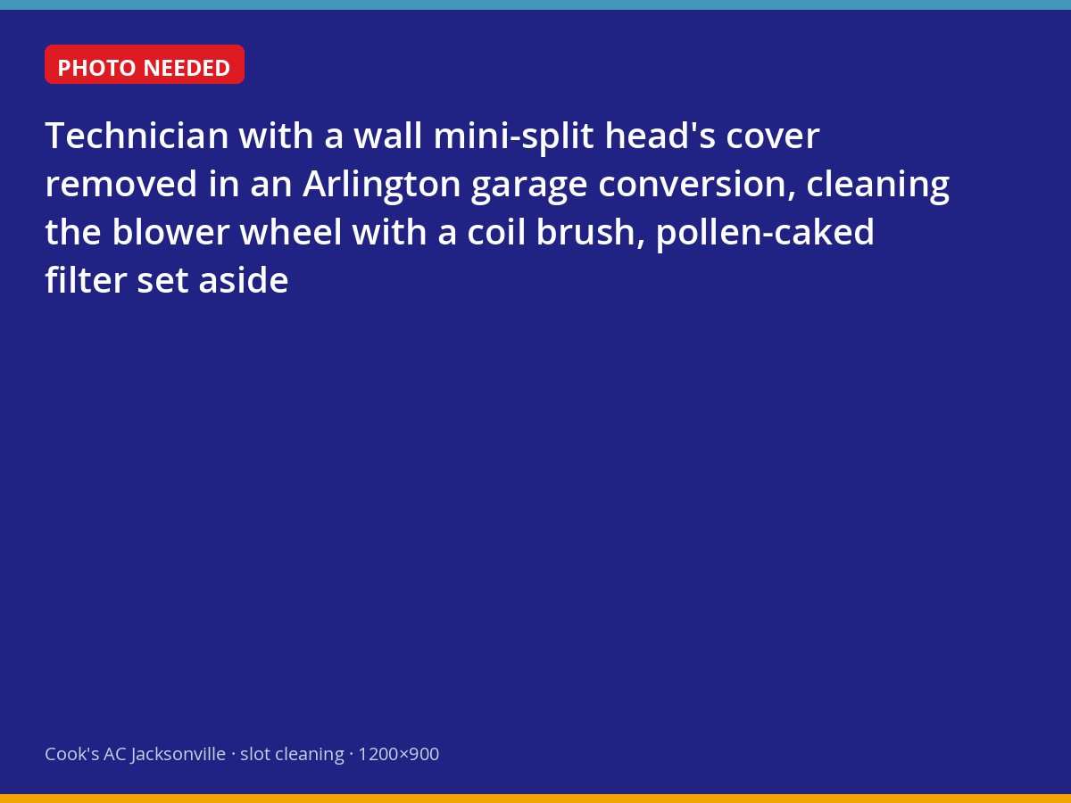 Technician deep-cleaning the blower wheel of a wall-mounted mini-split in a Jacksonville garage conversion