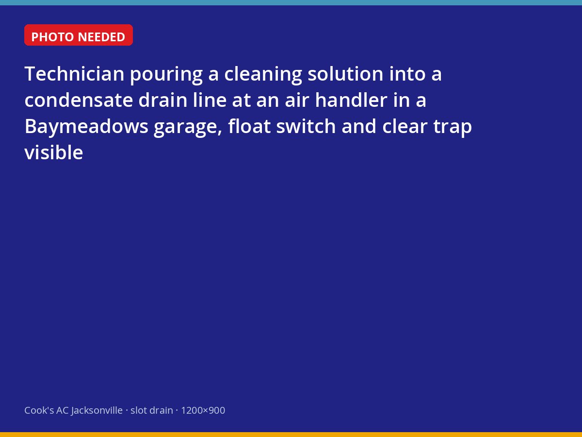 Technician flushing an air conditioner condensate drain in a Baymeadows garage